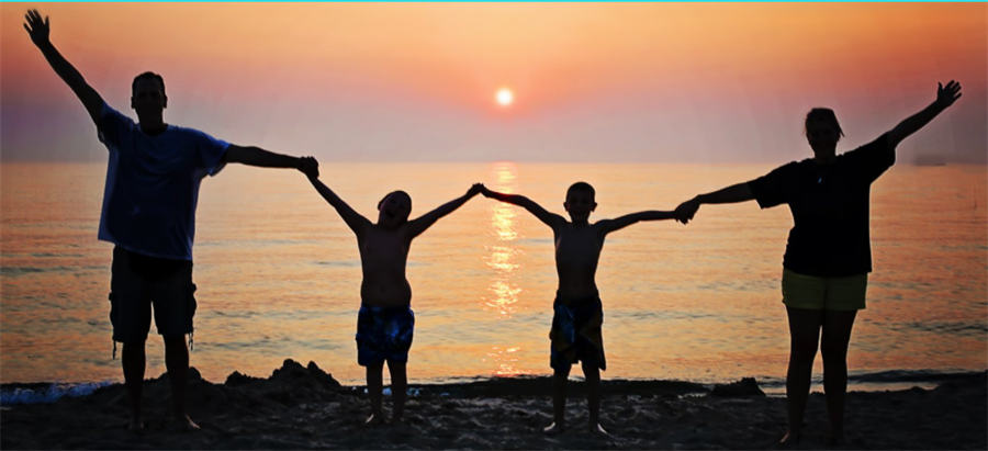 Family out in the beach during a sunset