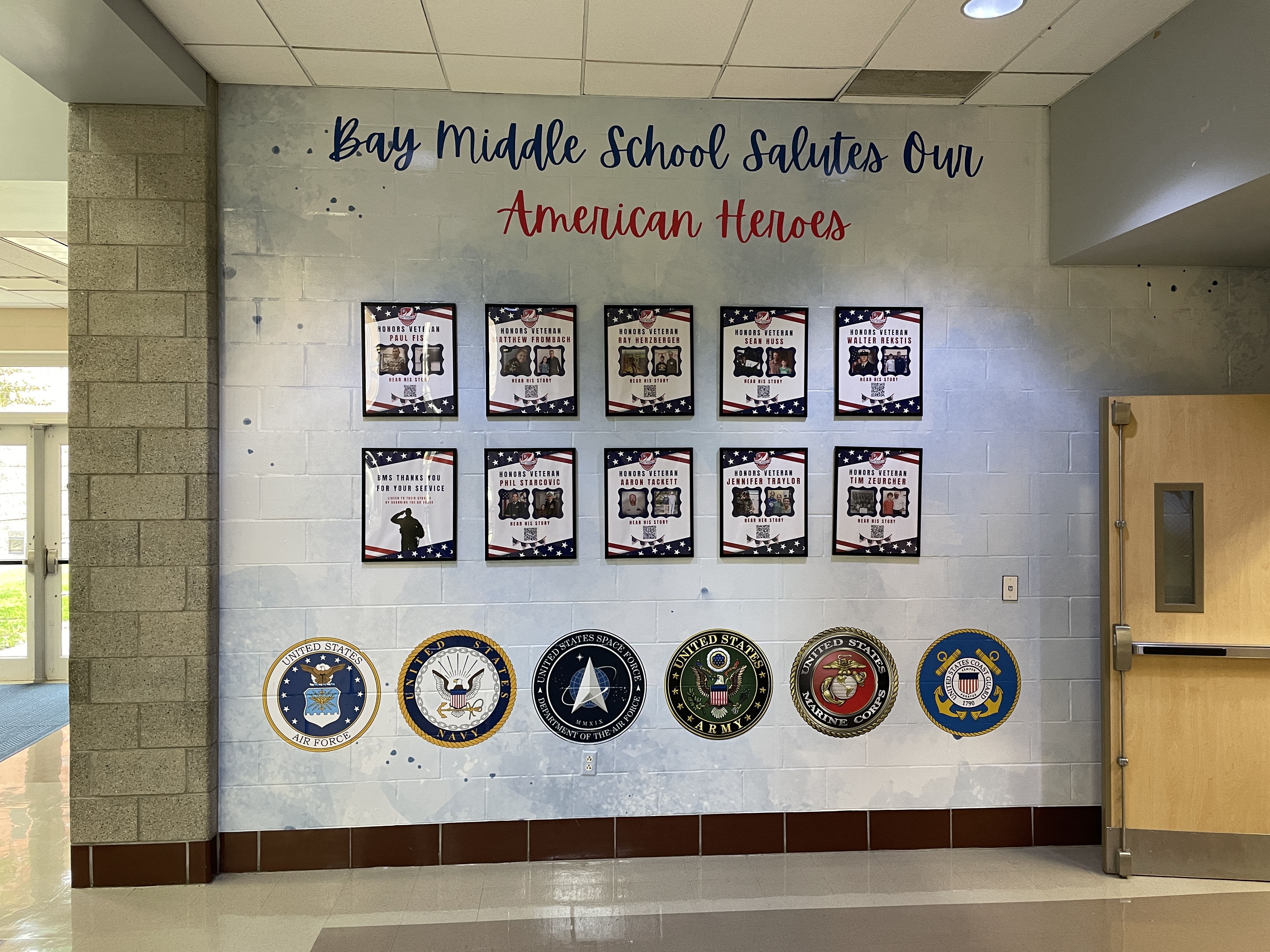 Bay Middle School's Veterans Honor Wall with military emblems, veteran bios and more.