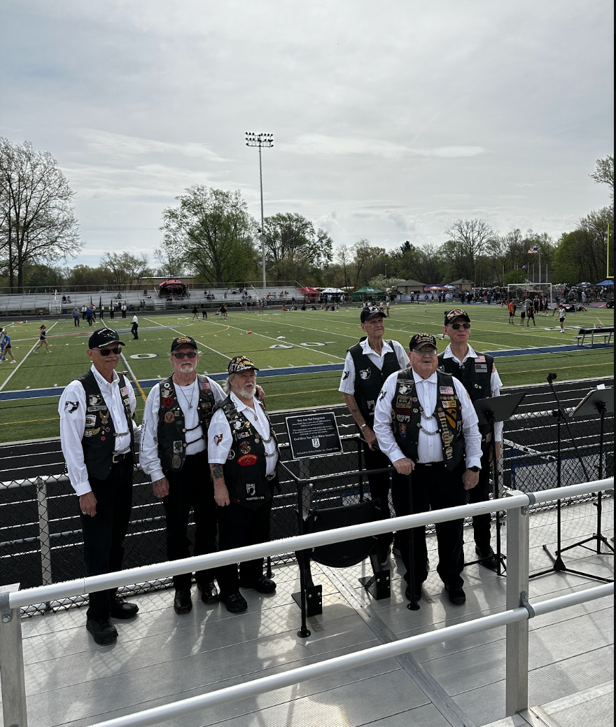 POW/MIA Honor Chair dedication with Rolling Thunder veterans posing alongside the empty chair at Bay Memorial Stadium.