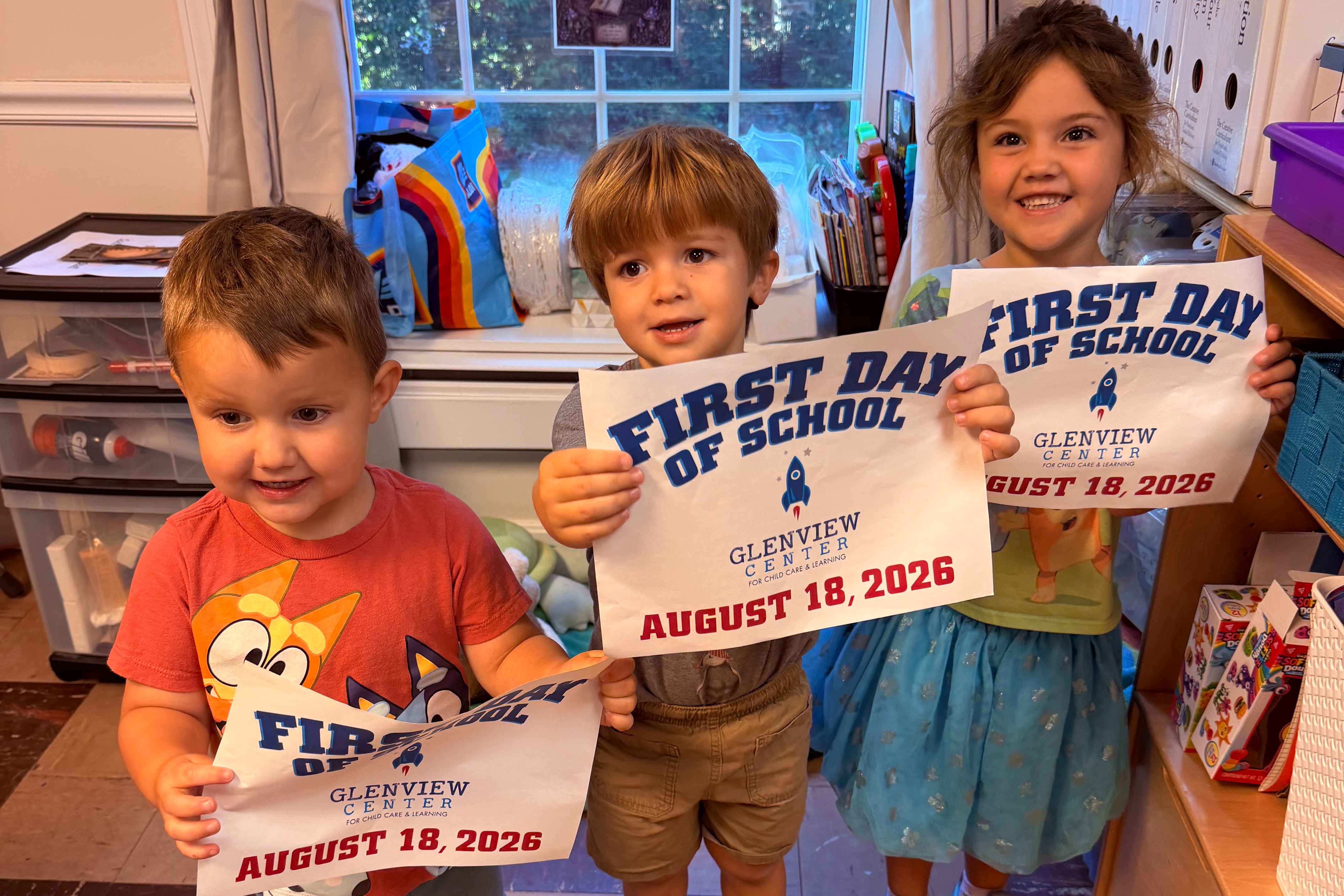 Glenview students on the first day of school, holding their first day of school signs in side their classroom.