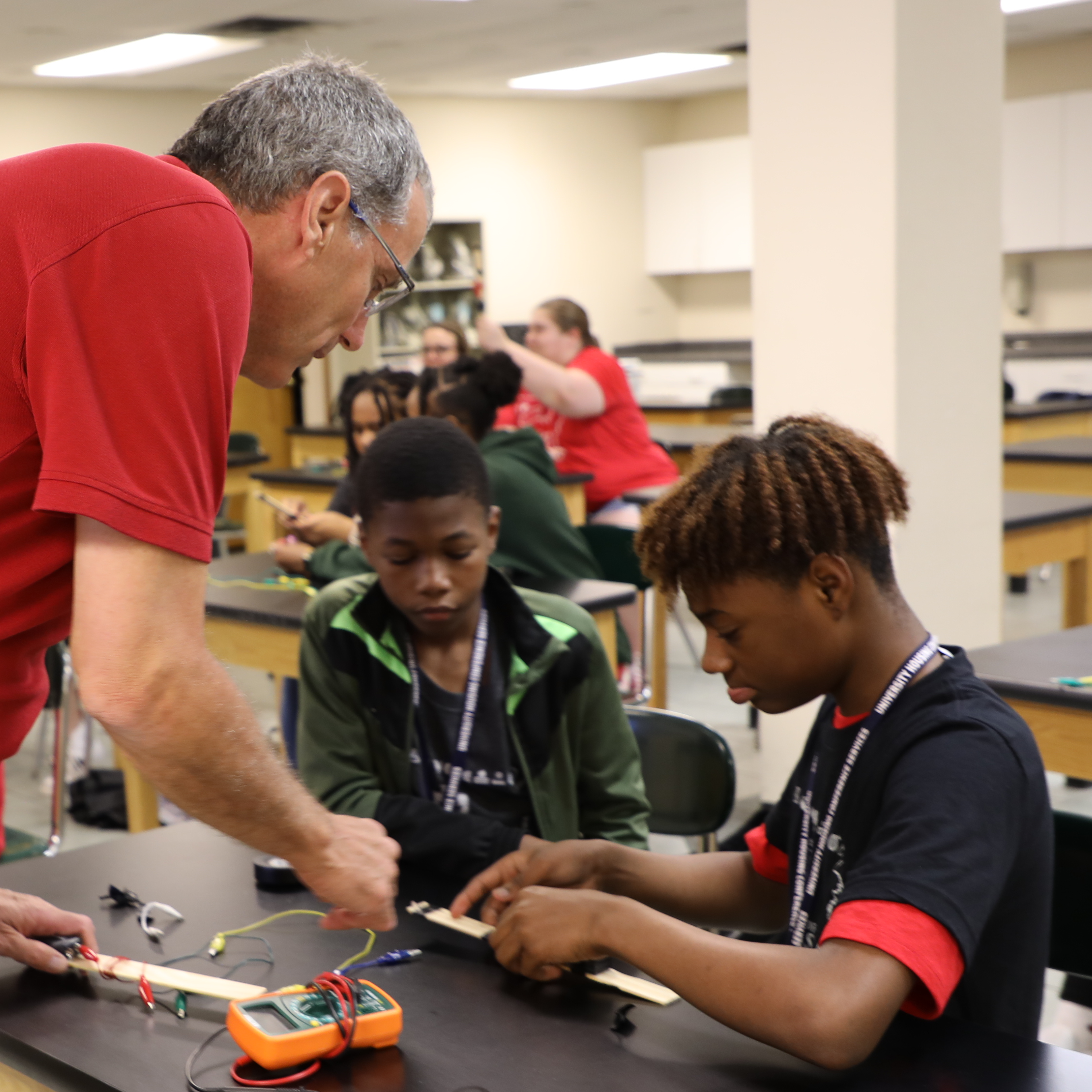 Students working with teacher on a project