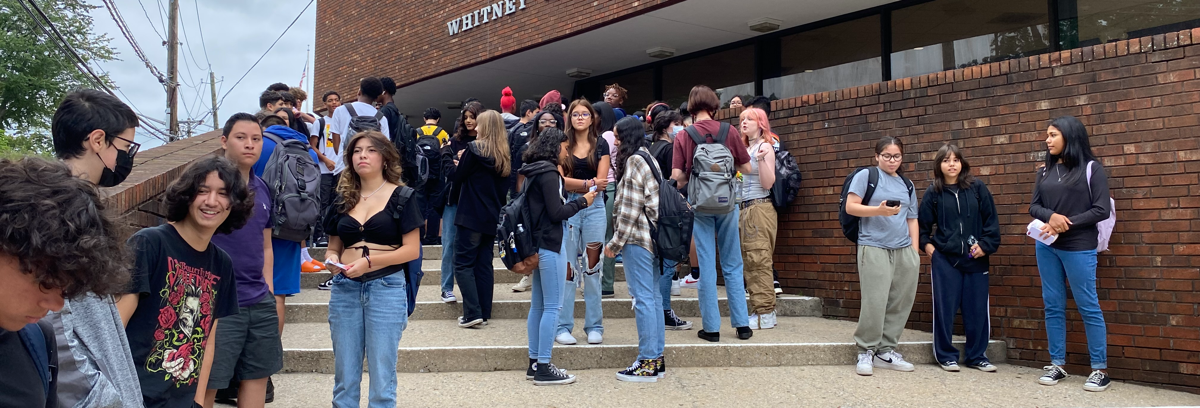 students outside of auditorium