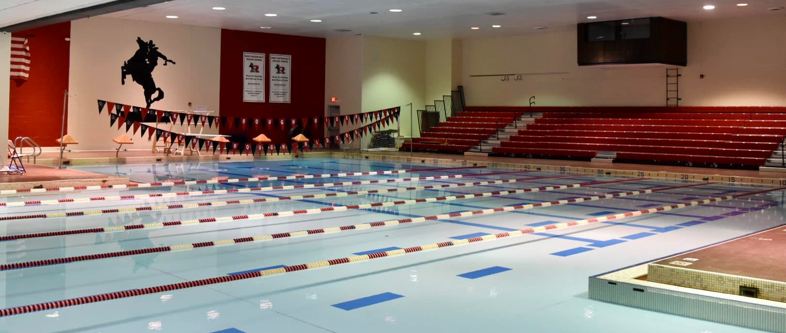 indoor pool with bleachers behind it