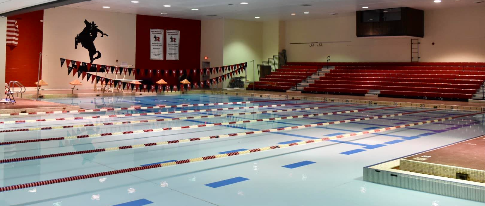 indoor pool with bleachers behind it