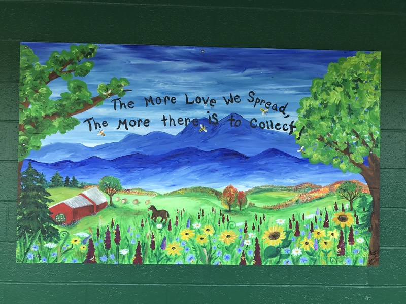 a painting that reads "The more love we spread, the more there is to collect"