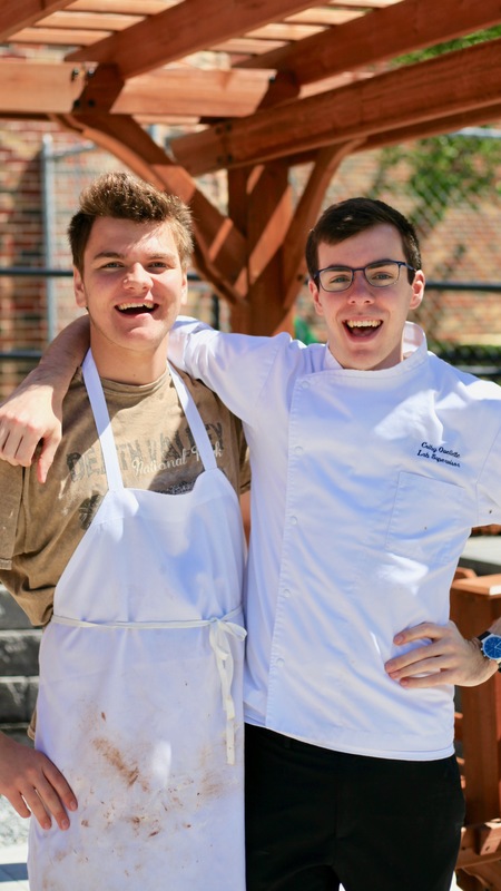 2 student chefs smiling for a picture