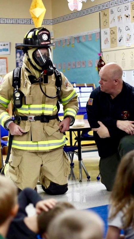 2 firemen talking to the students