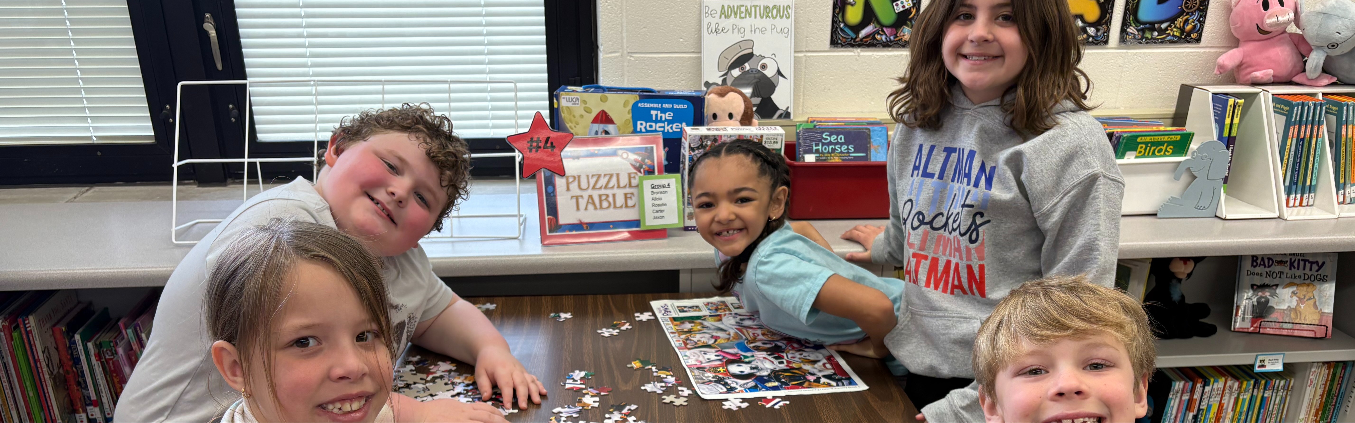Students in a classroom working on a puzzle