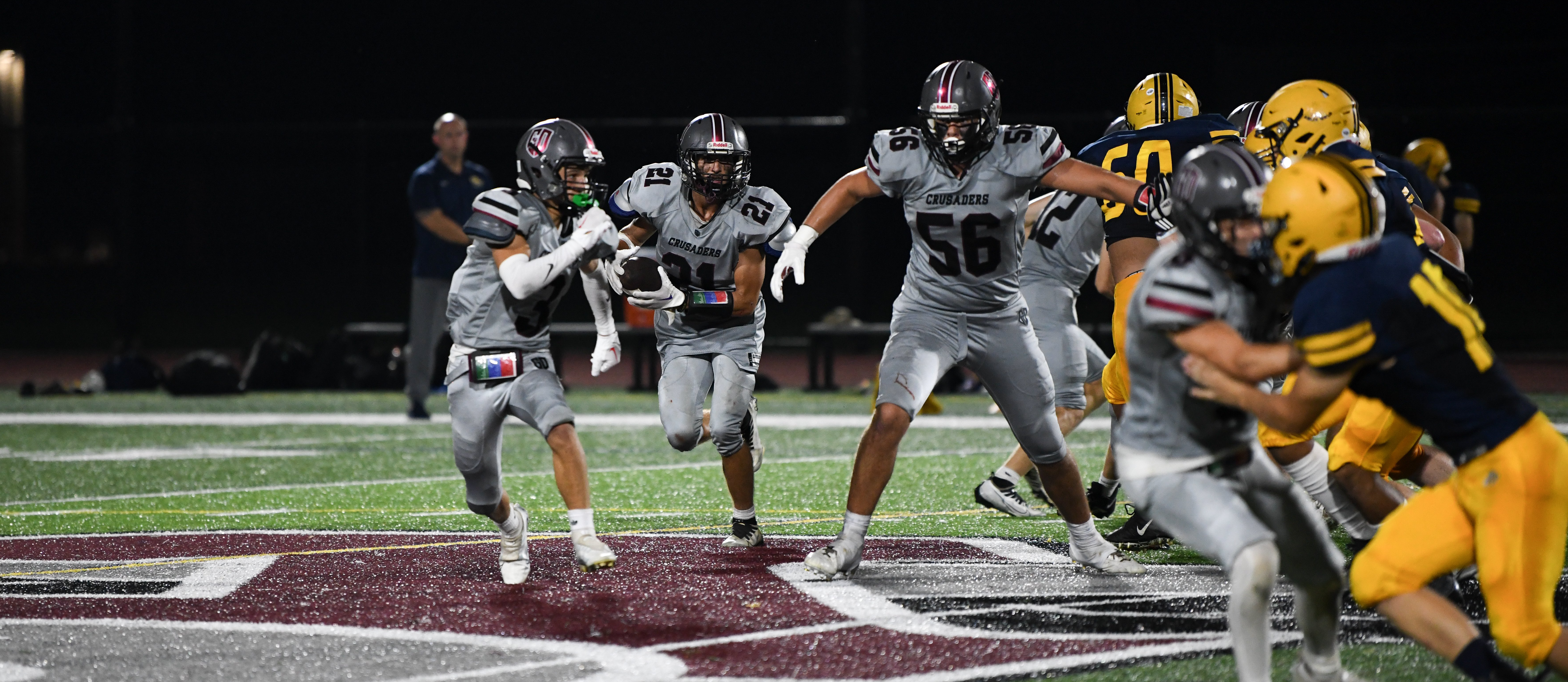 crusaders football running a play versus greater lowell tech