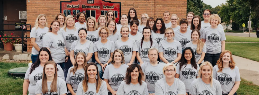 Rickard Elementary School staff group photo in front of the school building. 