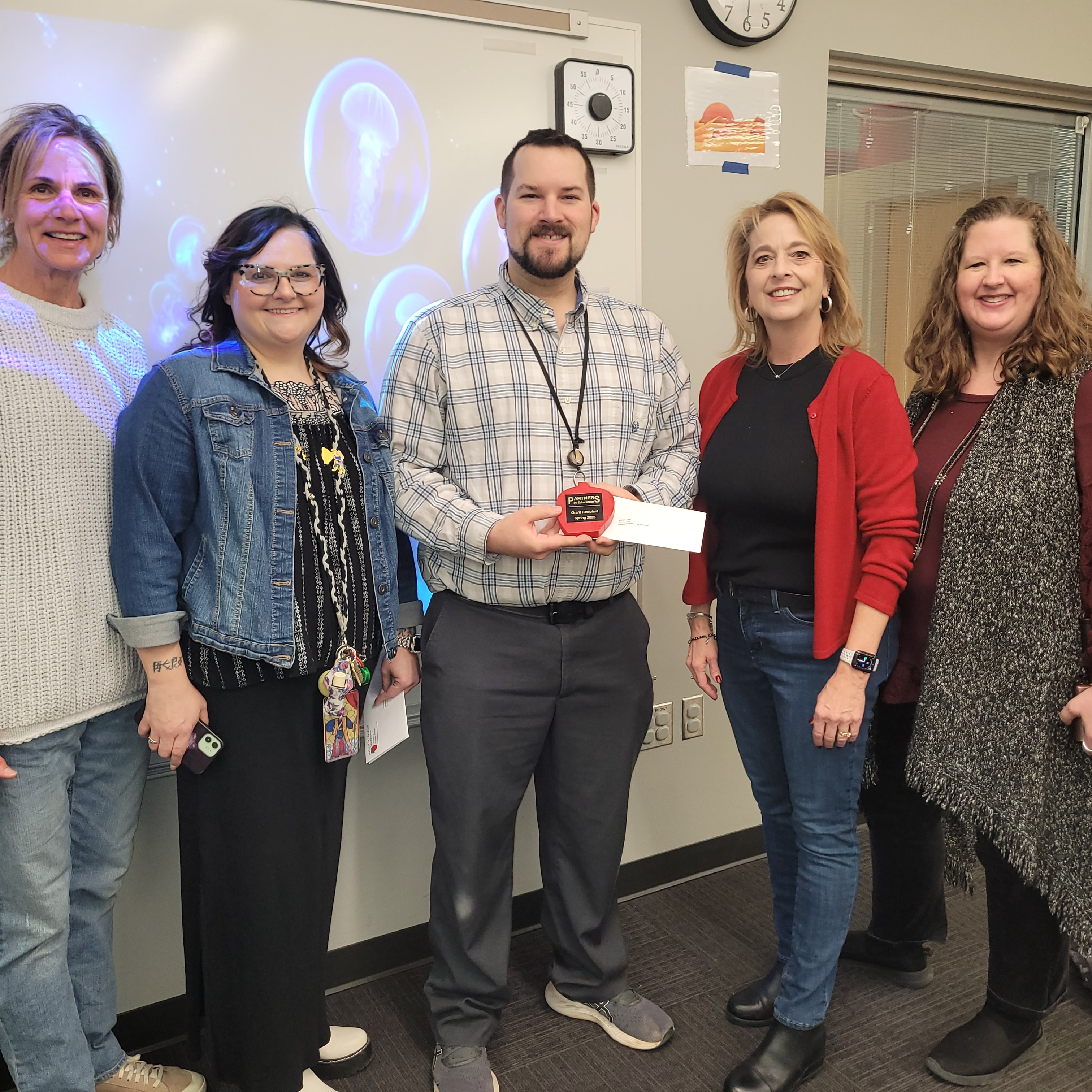 PIE delivering a grant award