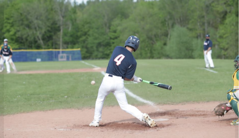 Baseball player hits the ball into the field