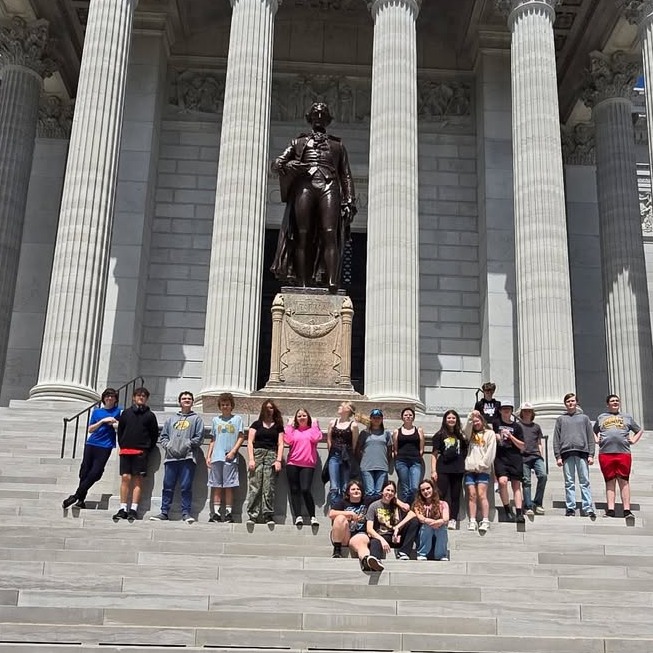 Students pose on steps of government building in Jefferson City