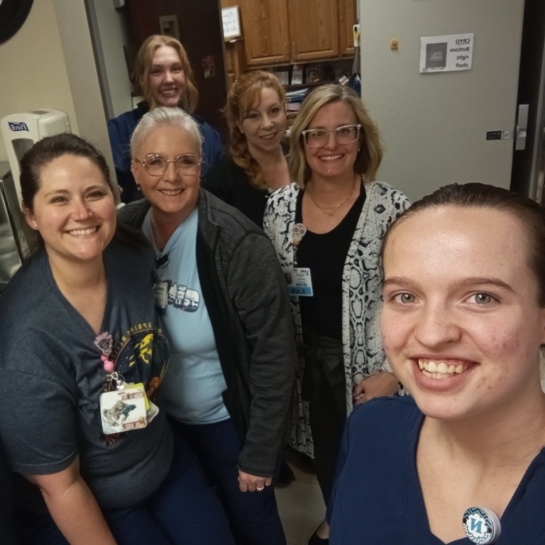 students pose with healthcare group during onsite training