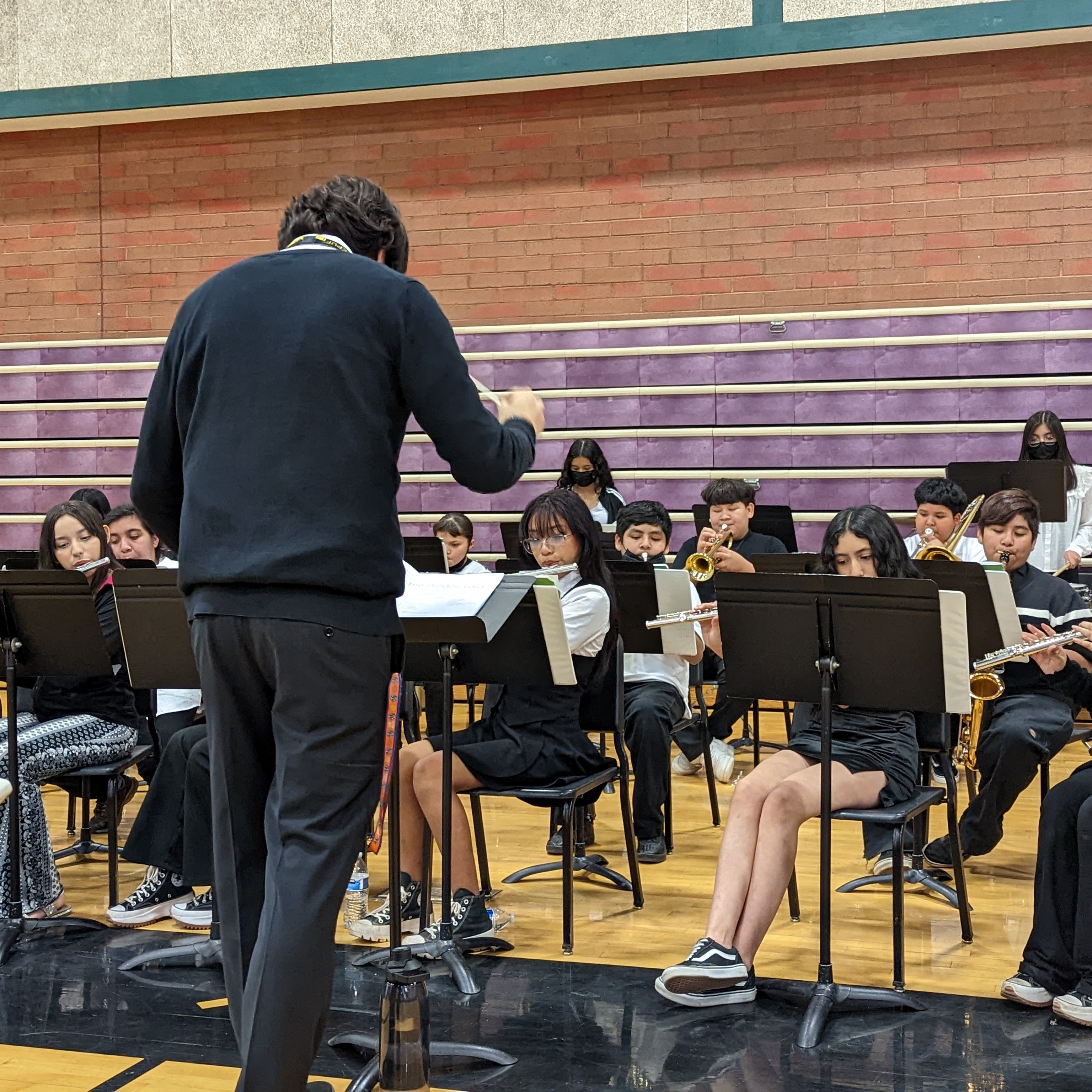 Band teacher and band students playing instruments