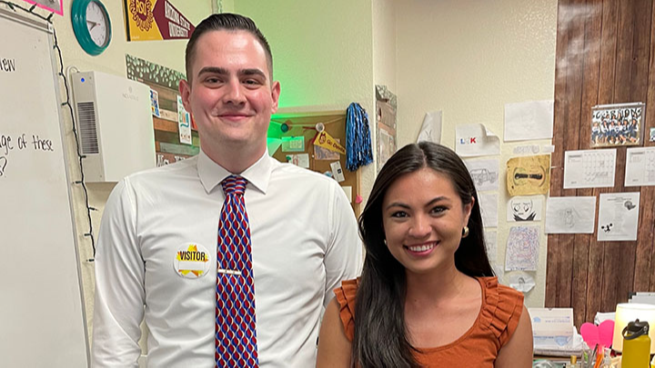 Middle school teacher and Burch and Cracchiolo law firm representative presenting the Star Teacher Award in her classroom.