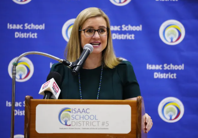Phoenix mayor Kate Gallego speaking in front of an ISD backdrop and podium of podium at press conference 