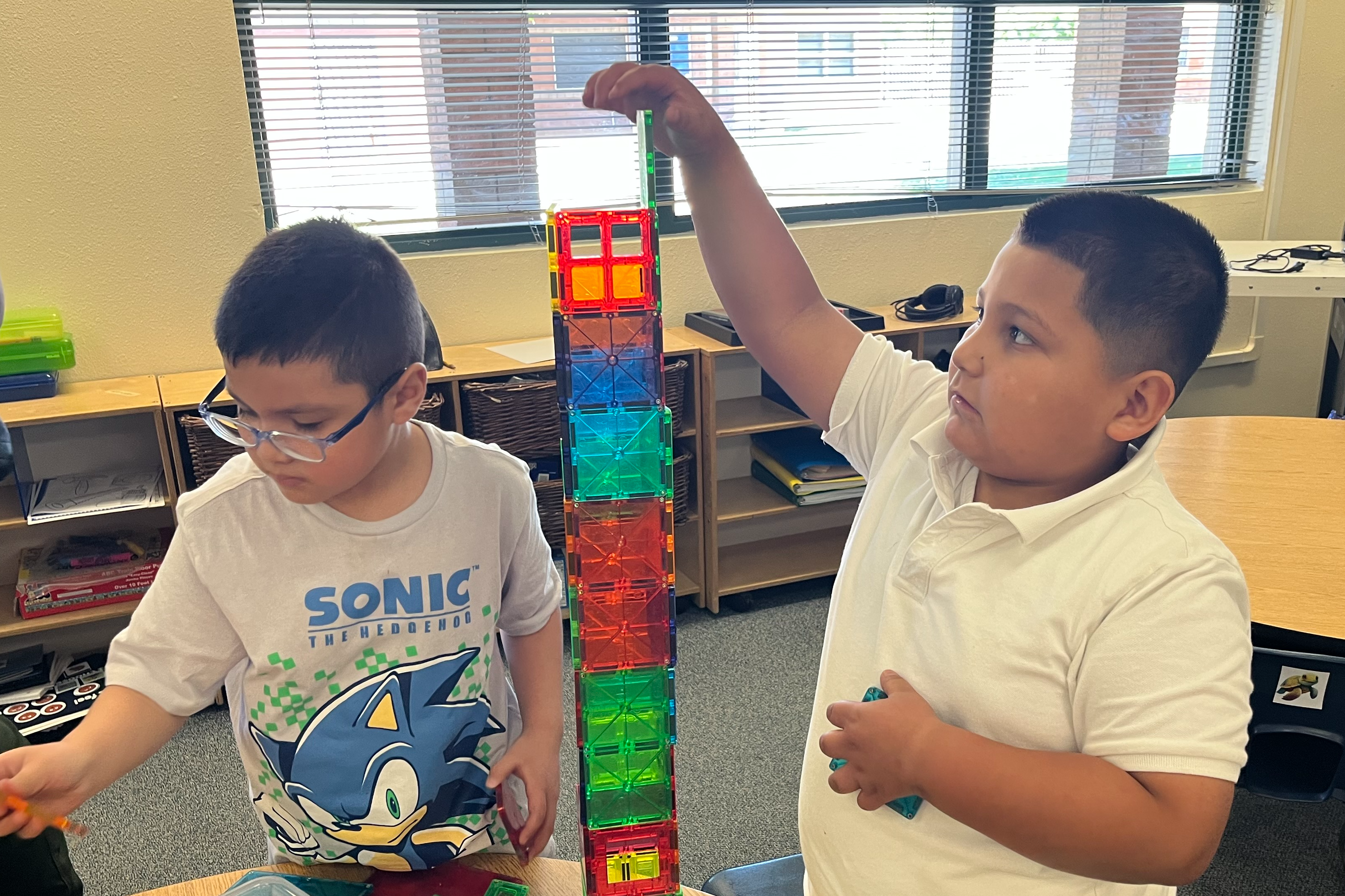 two student engaging in tower building puzzle