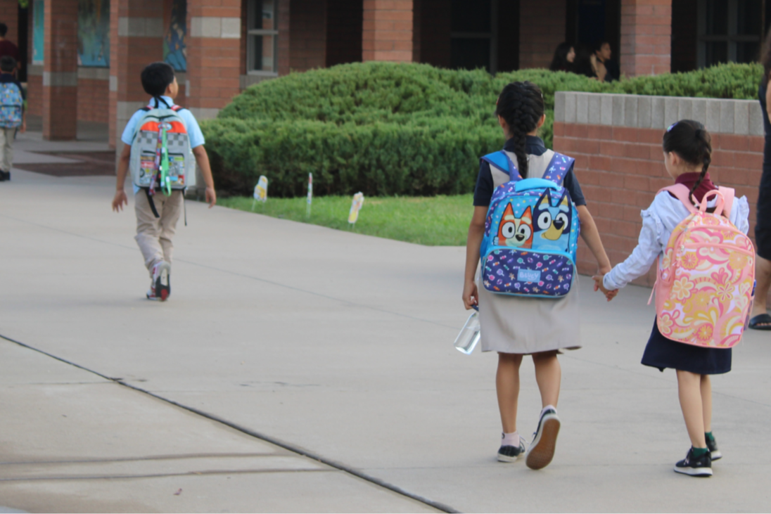 Esperanza students walking to class holding hands