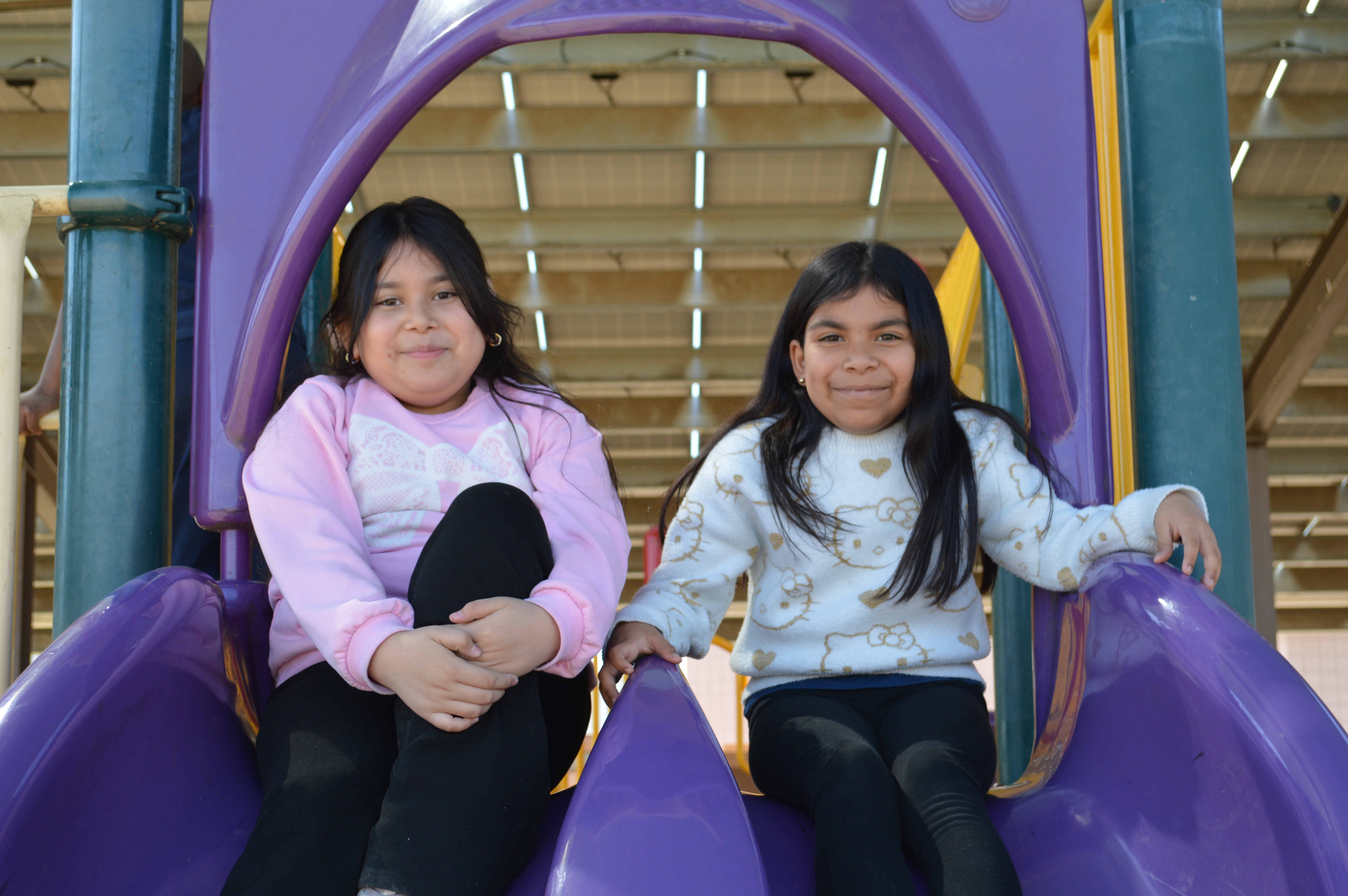 Students playing on the slide  at the playground