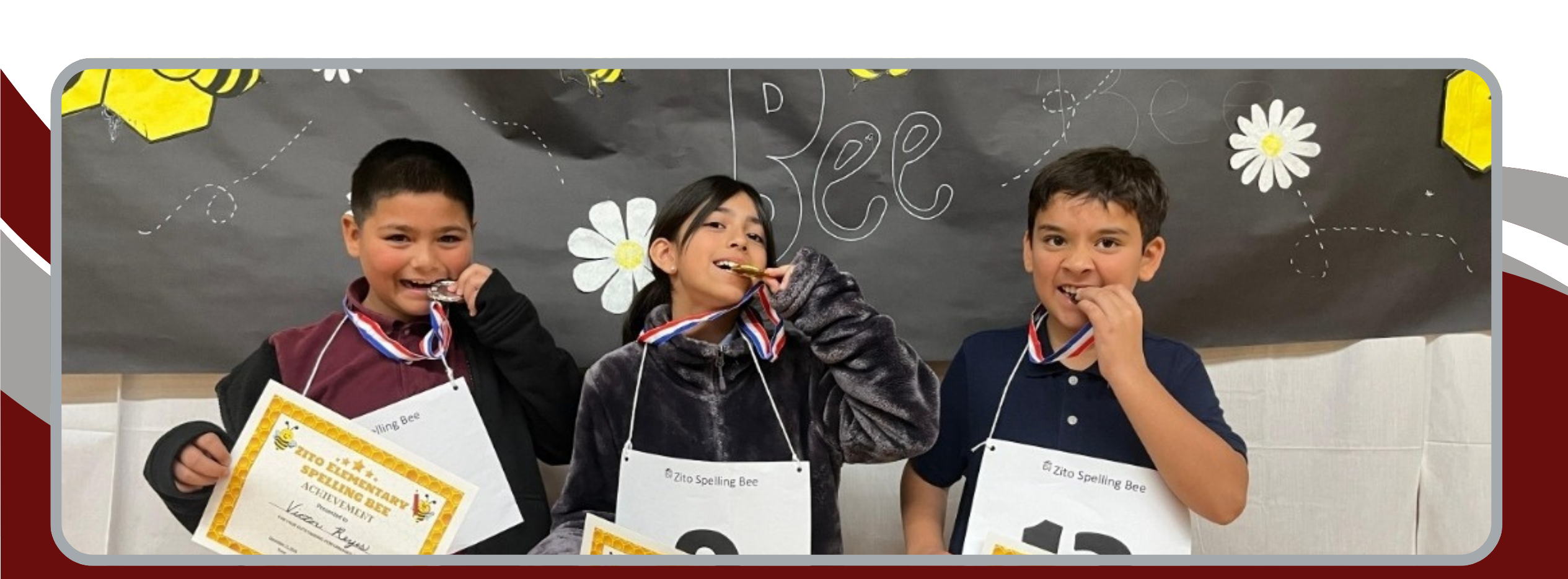 picture showing 2 kids biting on their medal