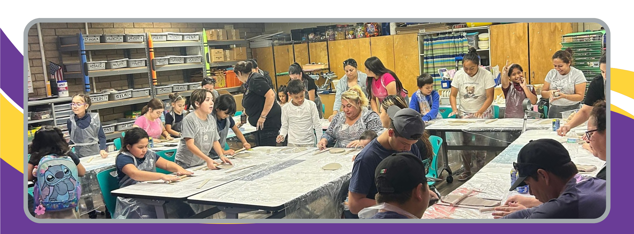 Families engaged in an art class making pottery