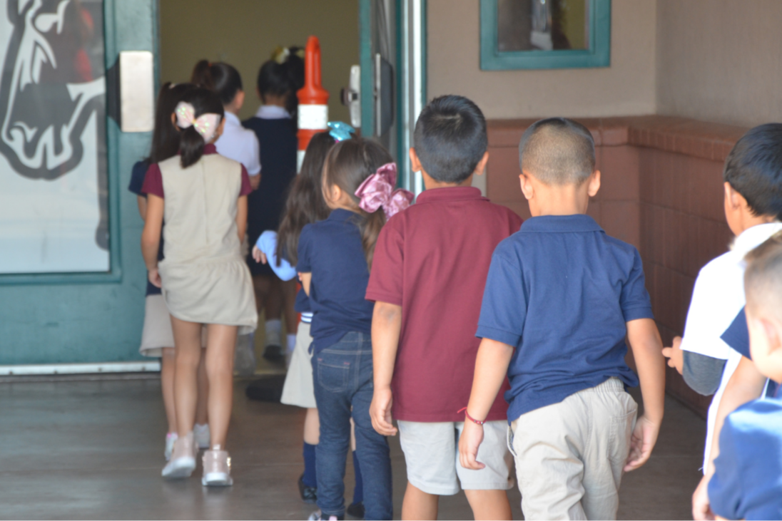 Enroll Today - moya students walking into building