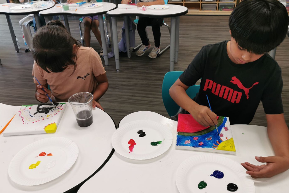 Enroll Today - Photo of students at table painting