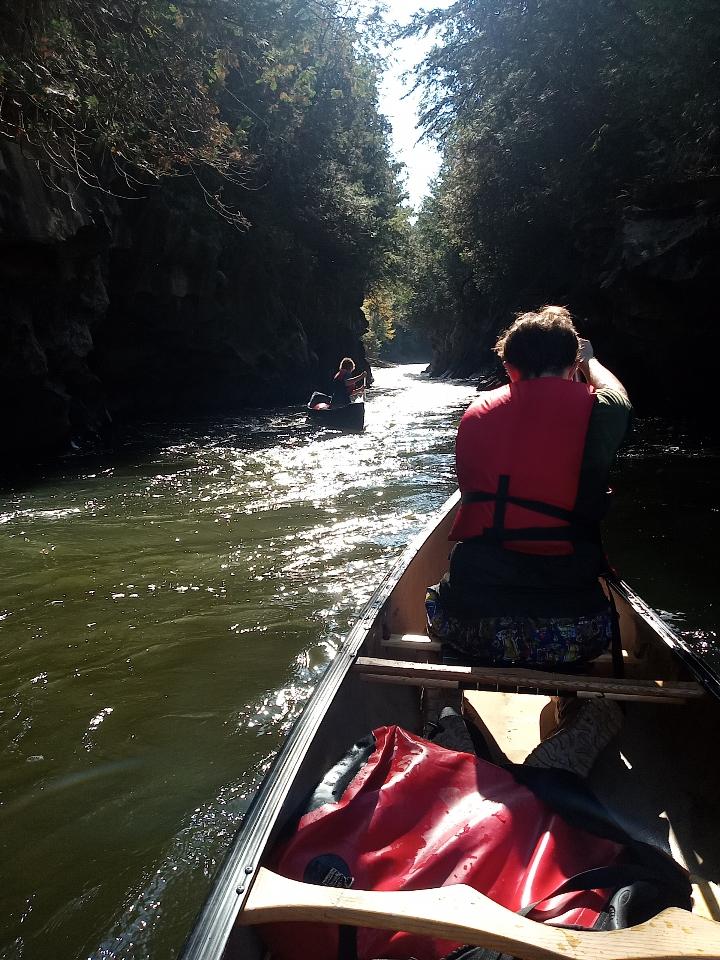 OV students canoeing down a narrow river