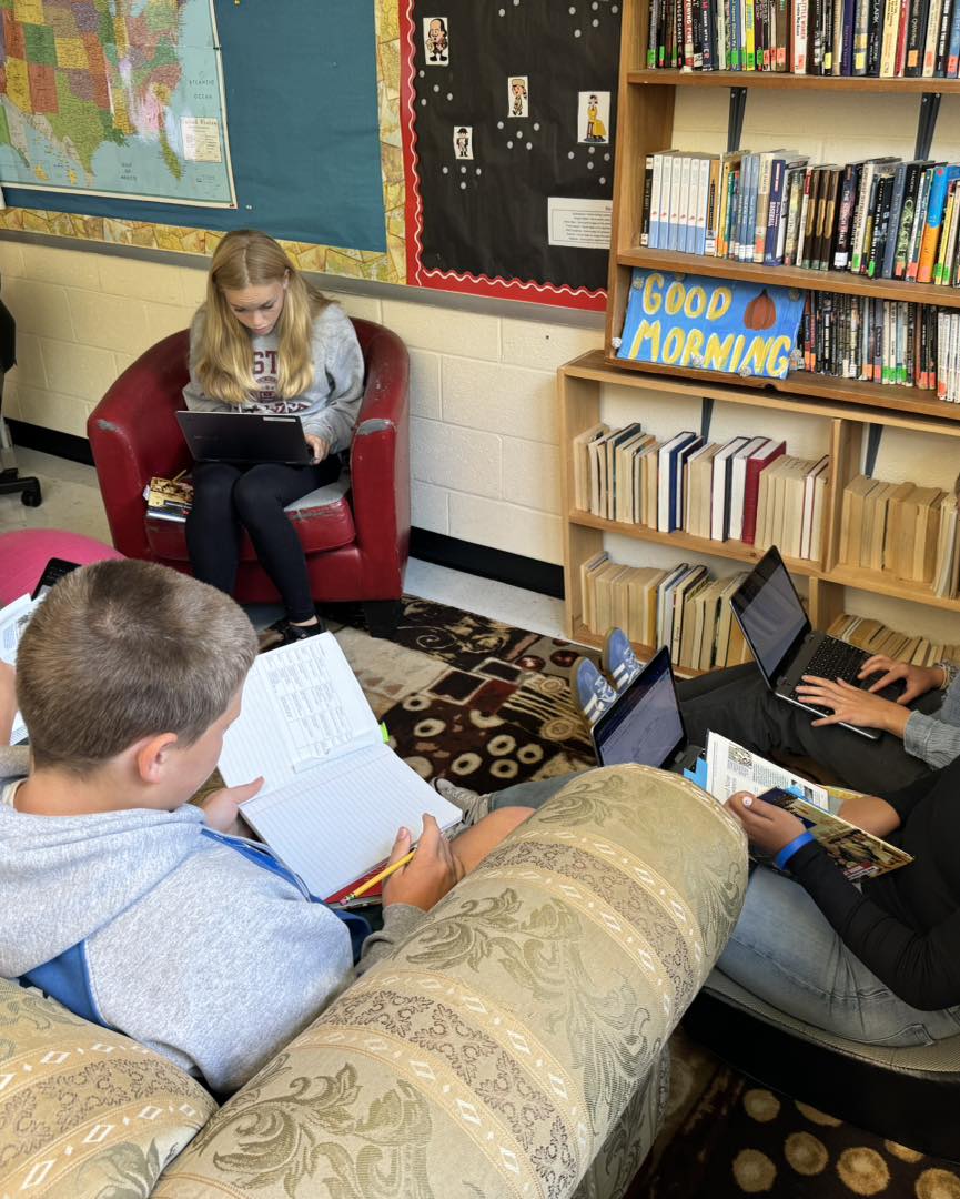 Barstow Students on Chairs reading and on computers