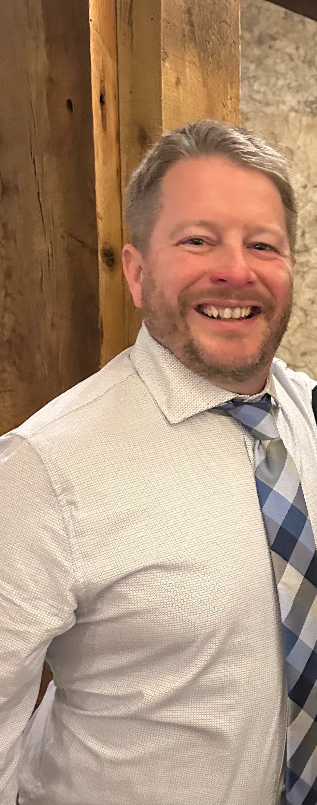 Matthew Hildebrand in a shirt and tie