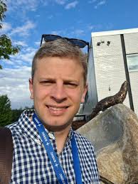 Michael Ruppel outside the OV building by the otter sculpture