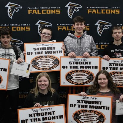 A group of students pose with their student of the month awards