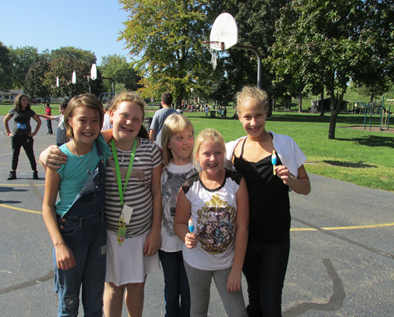 Kids out in recess and enjoying popsicles