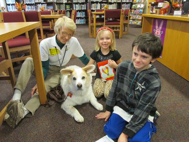 Students with the Fur Angels employee and a dog