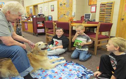 The kids interacting with a golden retriever