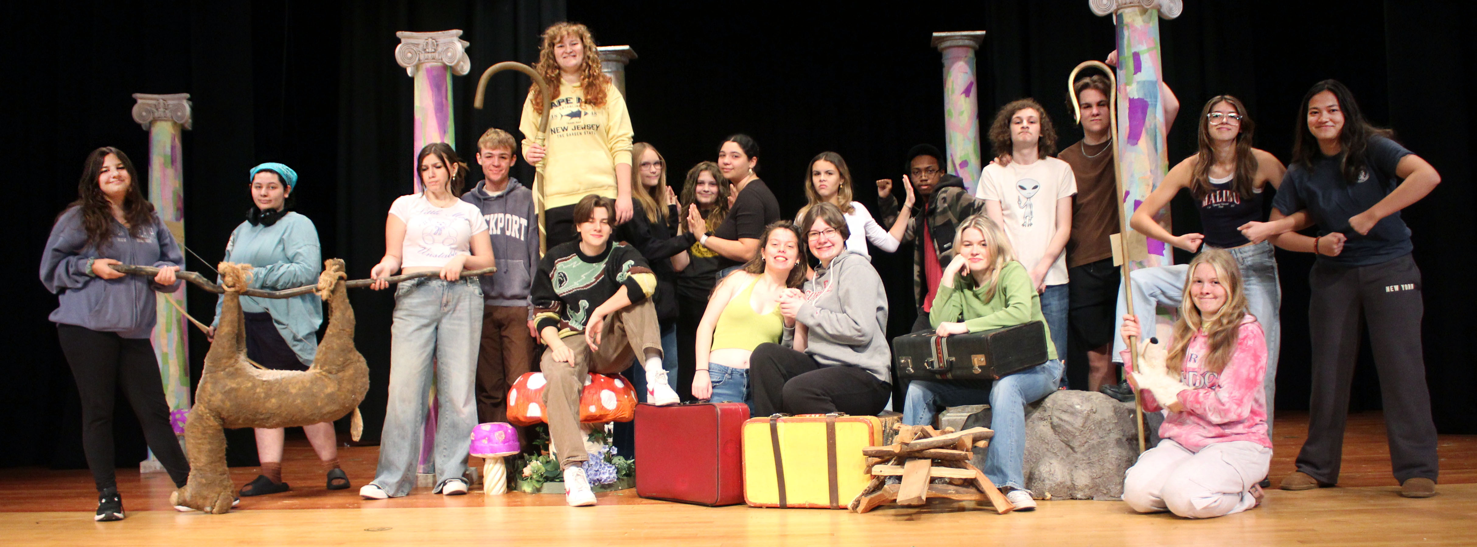 High school students pose for cast photo on stage