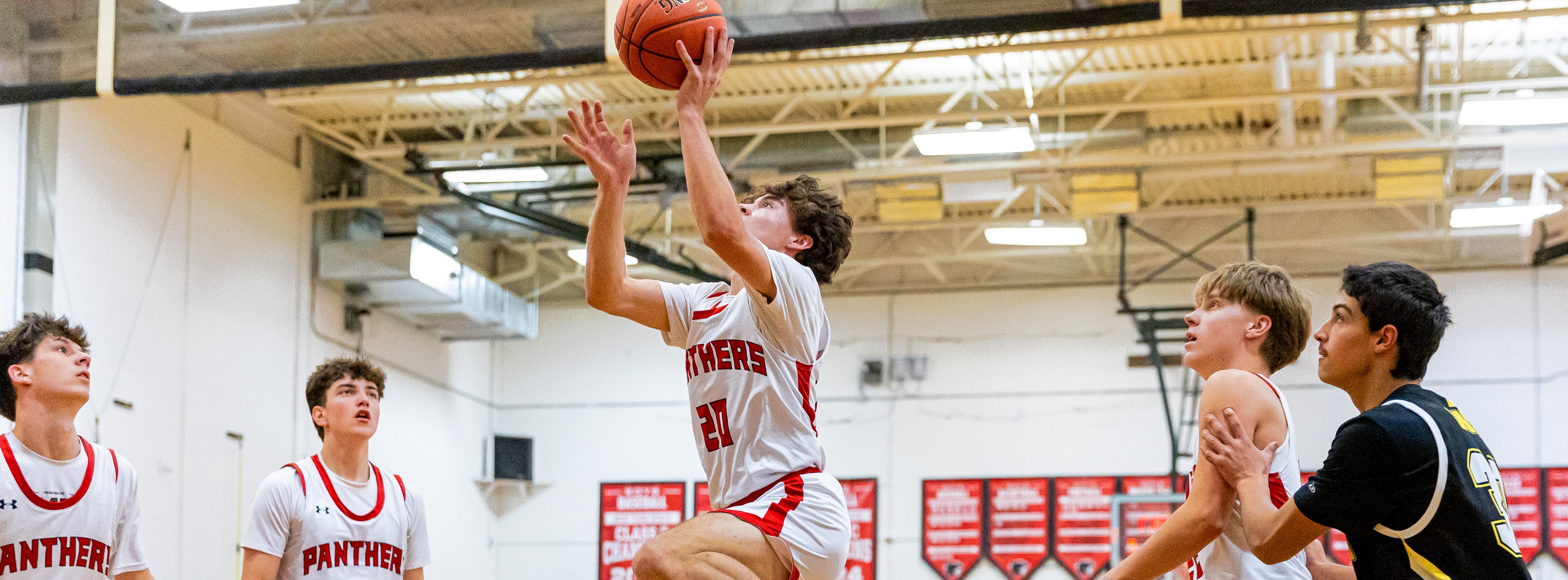 two basketball players doing a jump bump