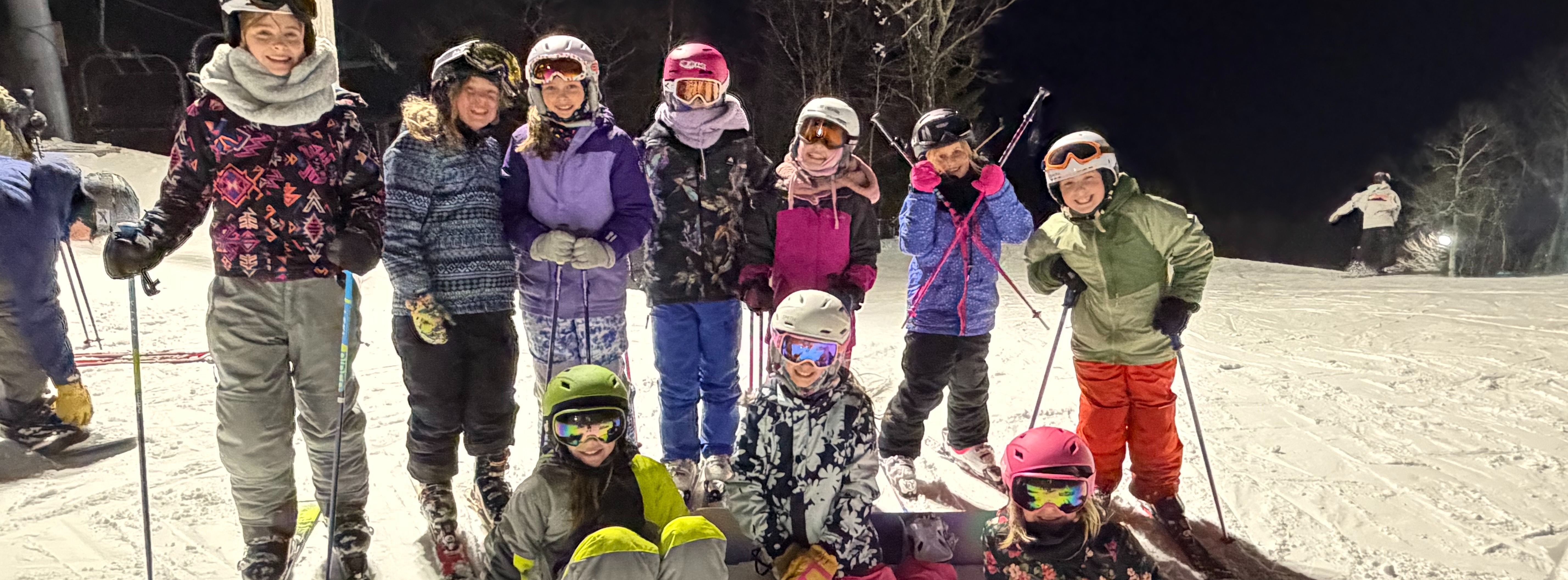 ski club poses for photo on ski slope