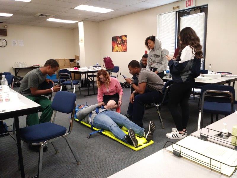 Classes of EMT, the students learning how to lift and move patients, learned body-mechanics and a safe delivery to a patient