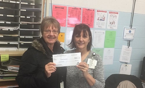 Caroline Patts presenting Colleen Ampezzan, PAES Lab Instructor, a $200.00 grant from the Taylor Public Schools Foundation for Educational Excellence.