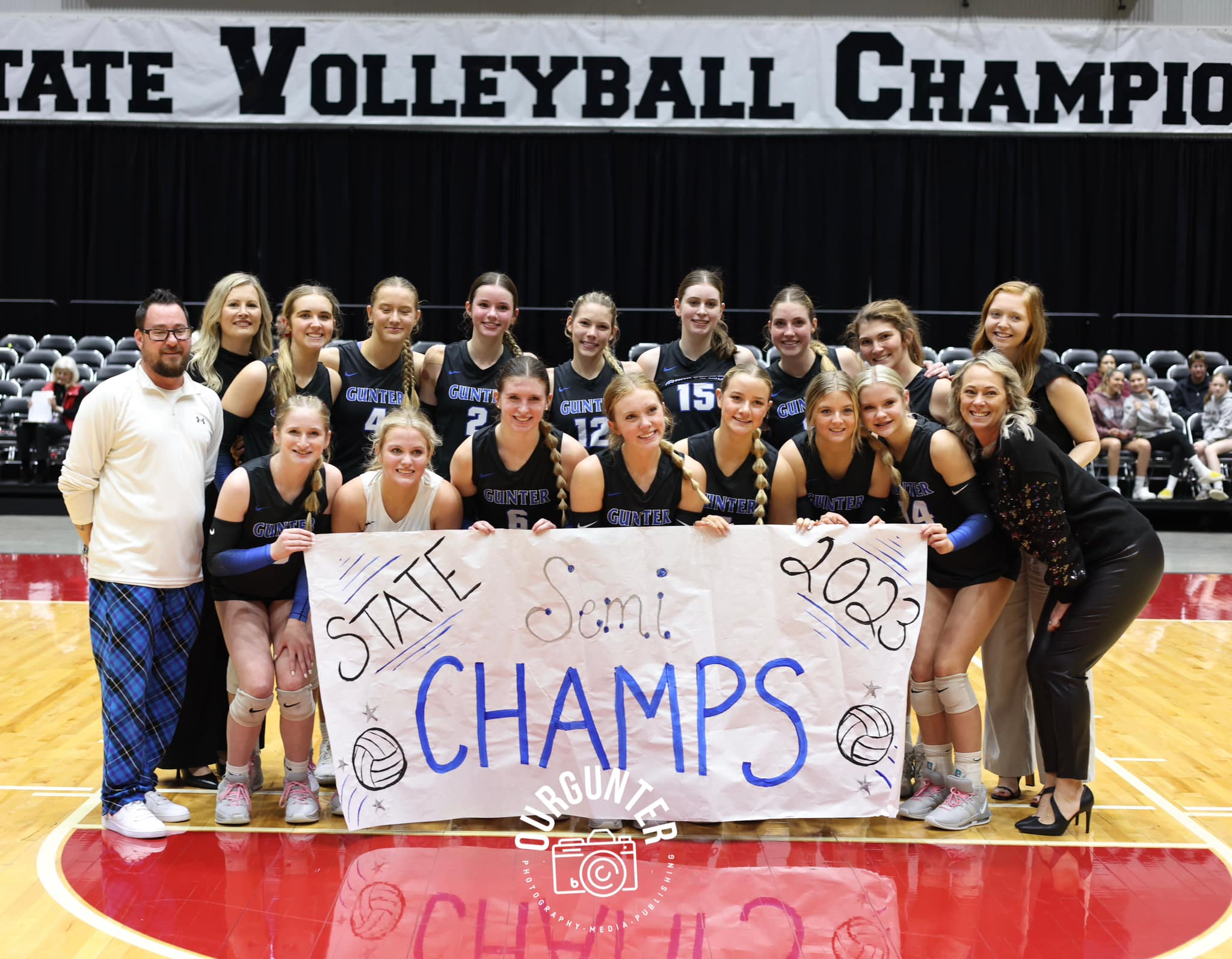 Volleyball team with sign