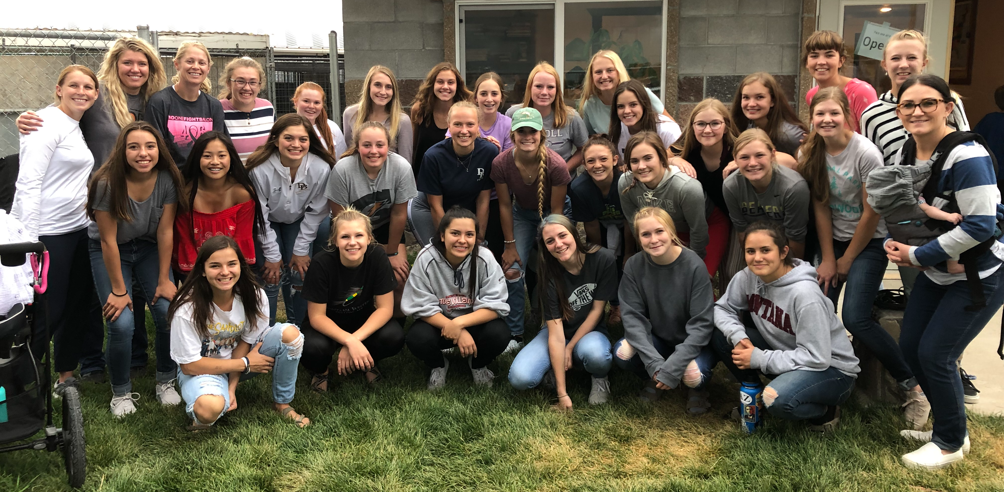 A photo of the volleyball team walking dogs at the local Humane Society in September 2019