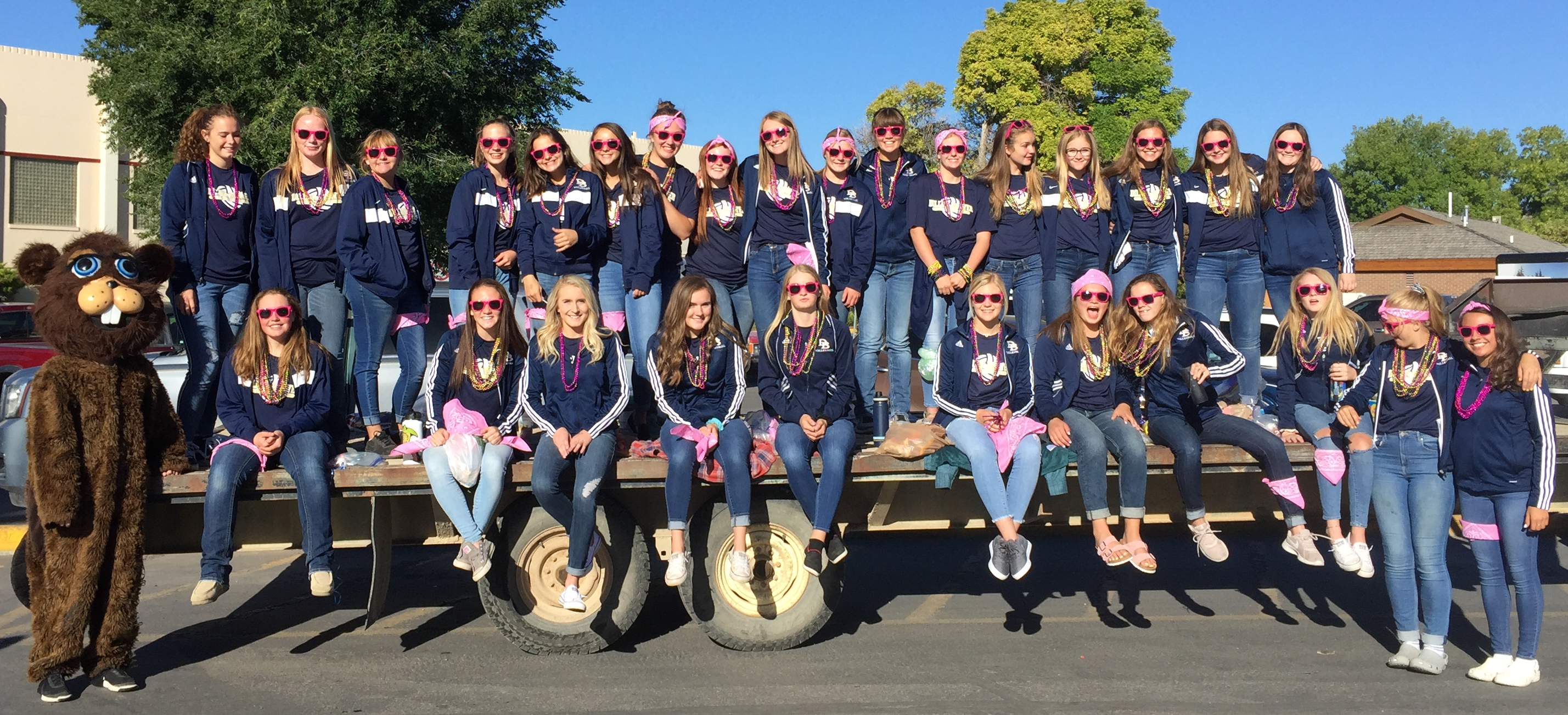 A photo of the volleyball team decked out in pink for the Labor Day parade in September 2018