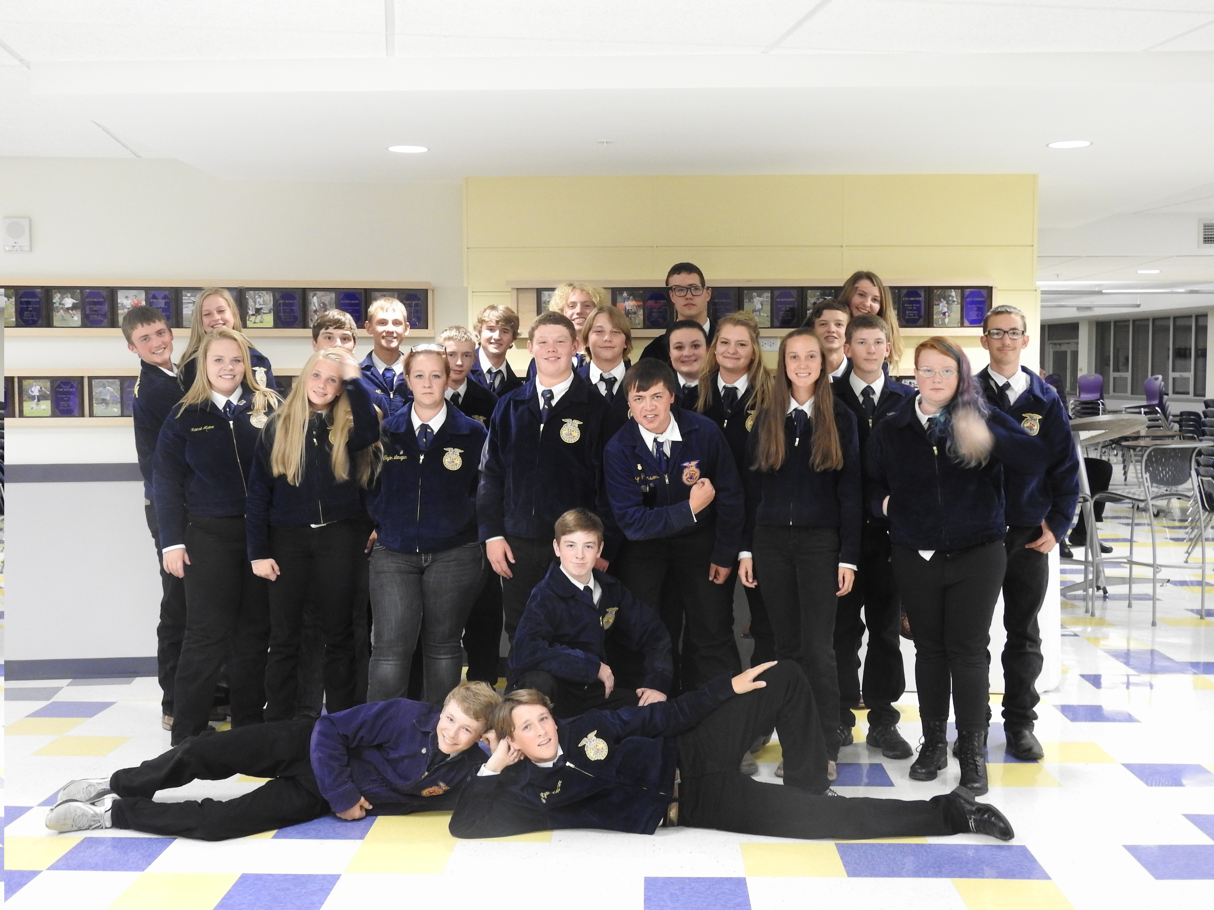 A group photo of the FFA team posing in the school hallway