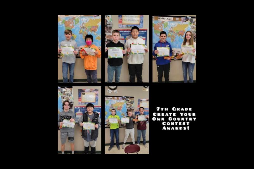 7th grade create your own country contest awards.  7th graders holding their certificates.