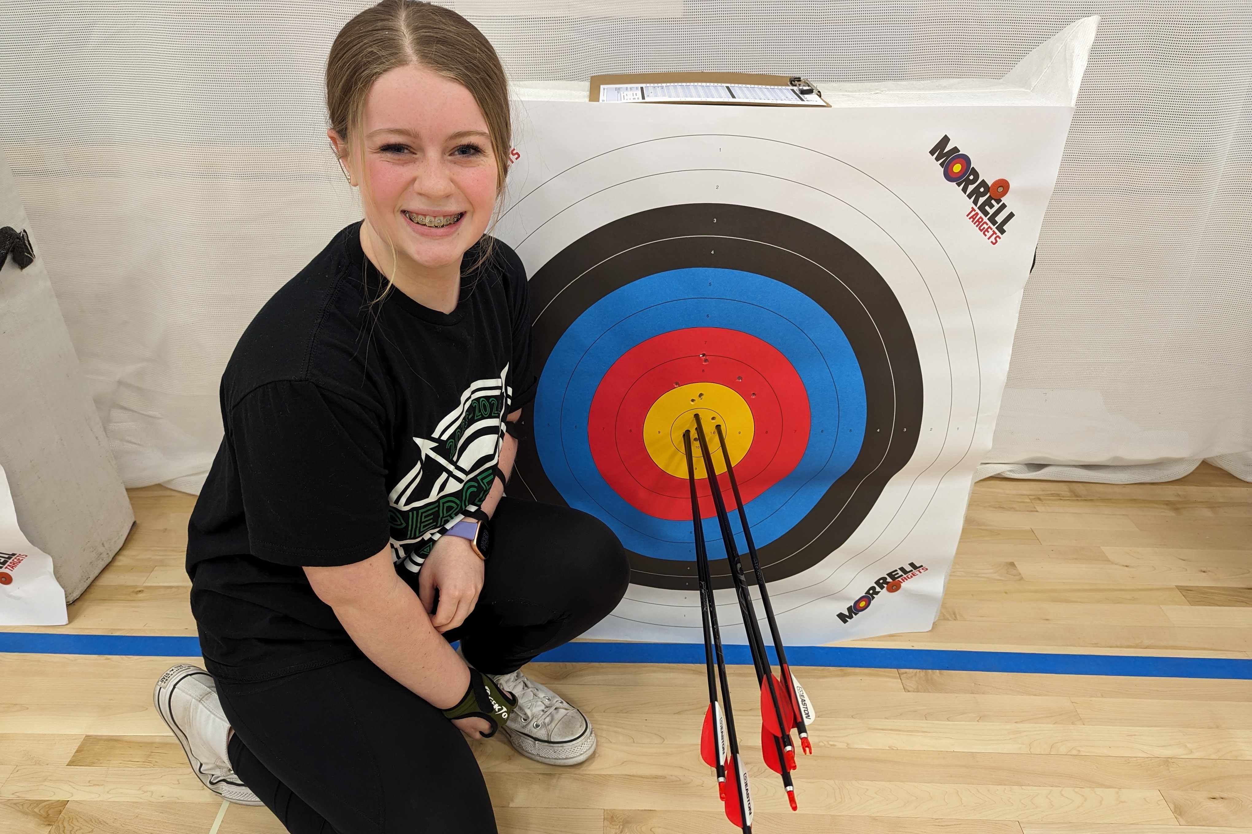 Makenna and target with her arrows from shooting perfect 50.