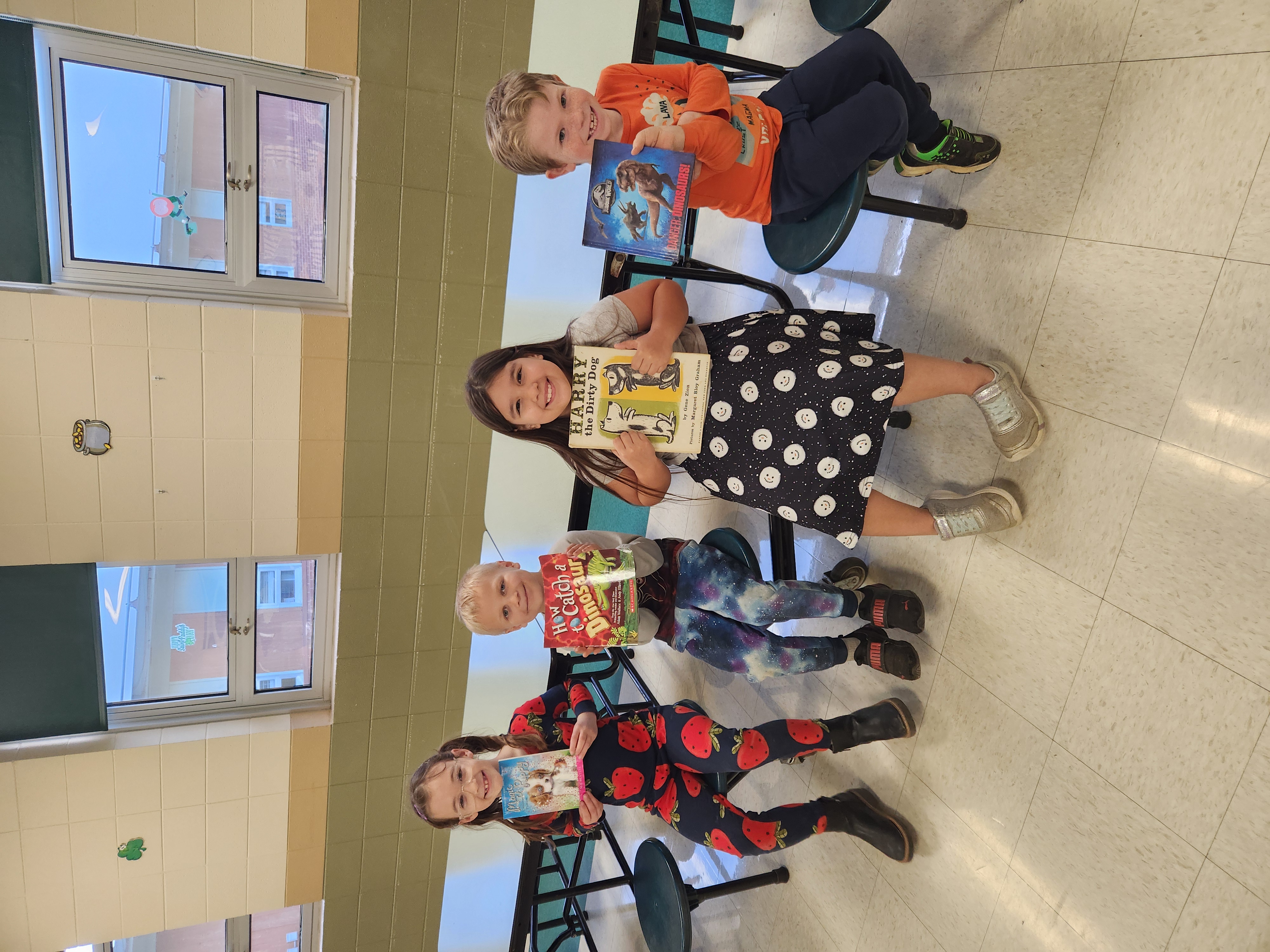 elementary students holding books
