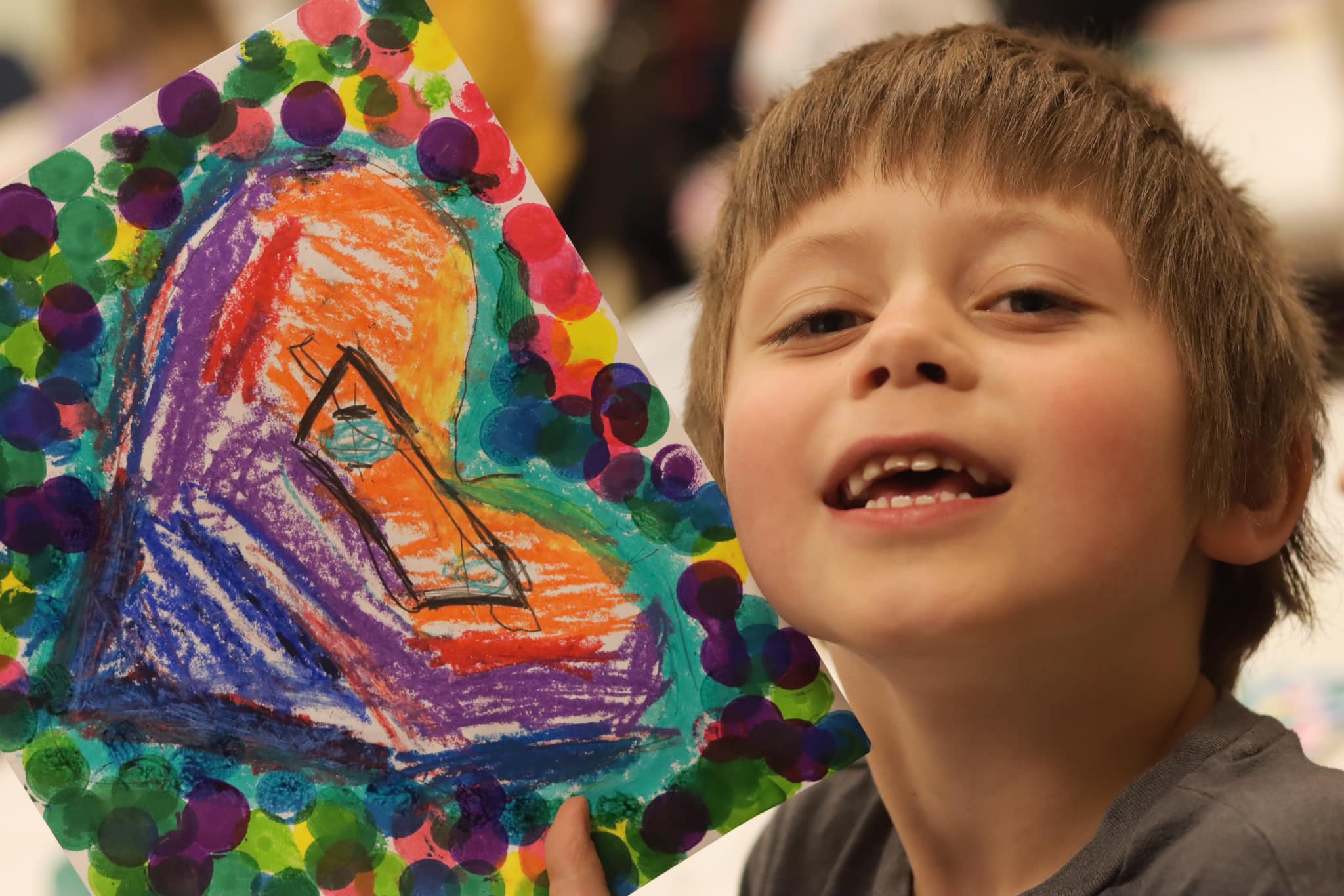 Kindergarten student at Washington Elementary School shows heart artwork