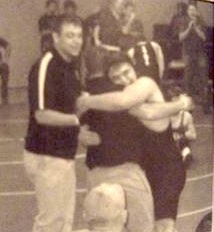 Wrestler hugging coach